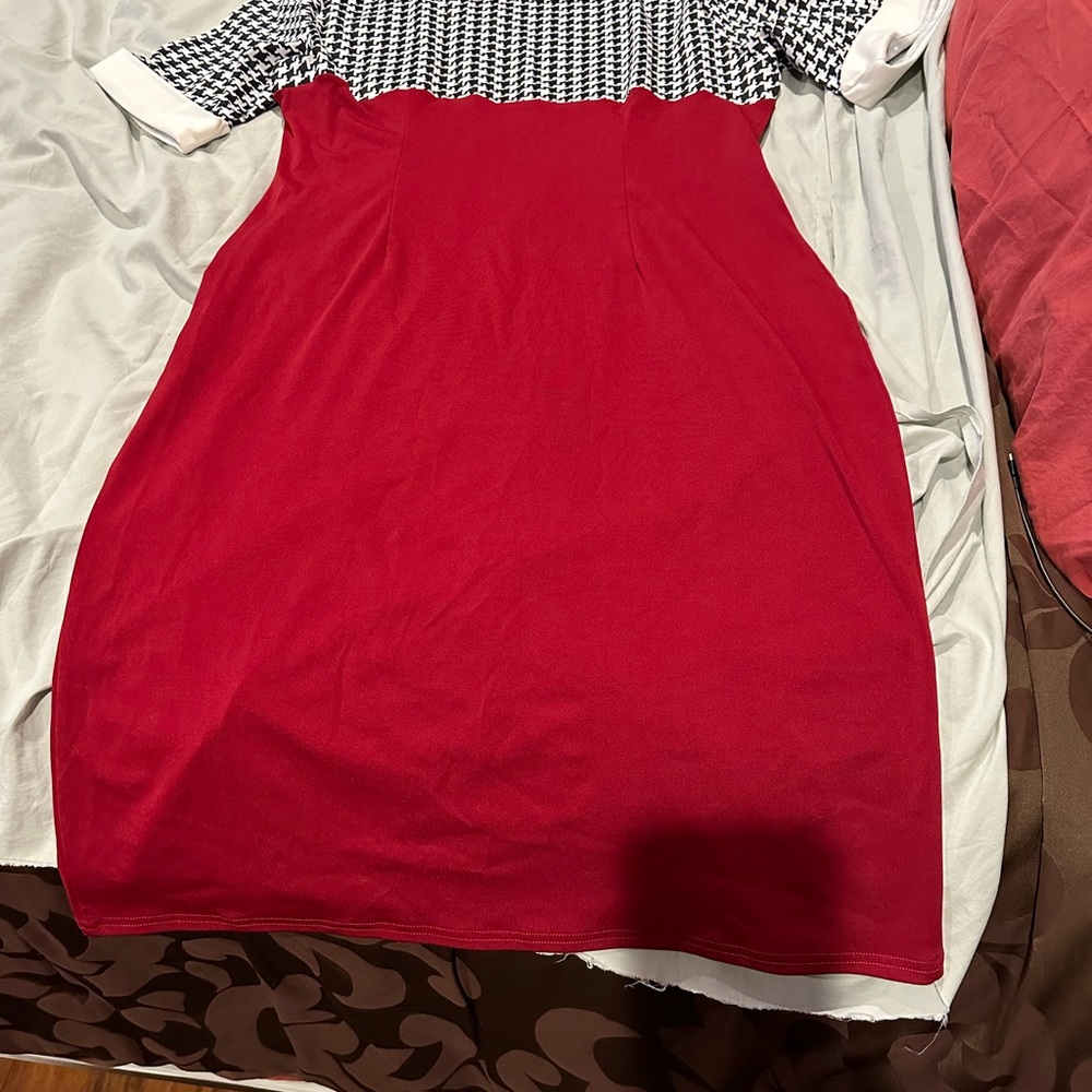 Womens short sleeve dress top is houndstooth black-and-white, bottom is red.